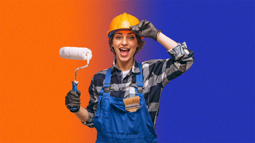 Ragazza che imbianca parete colorata con rullo professionale